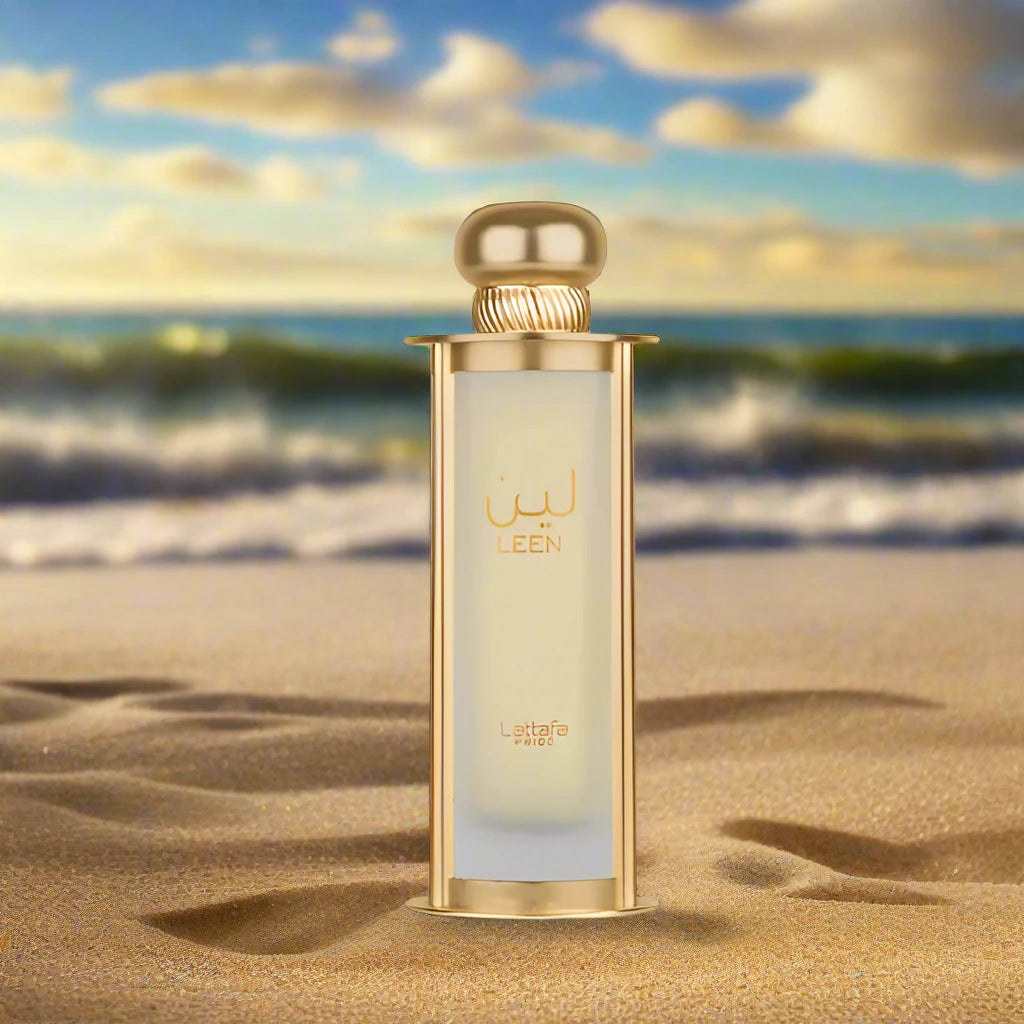 A sleek, transparent perfume bottle with a gold cap, labeled 'Jasmine Essence,' surrounded by white jasmine flowers